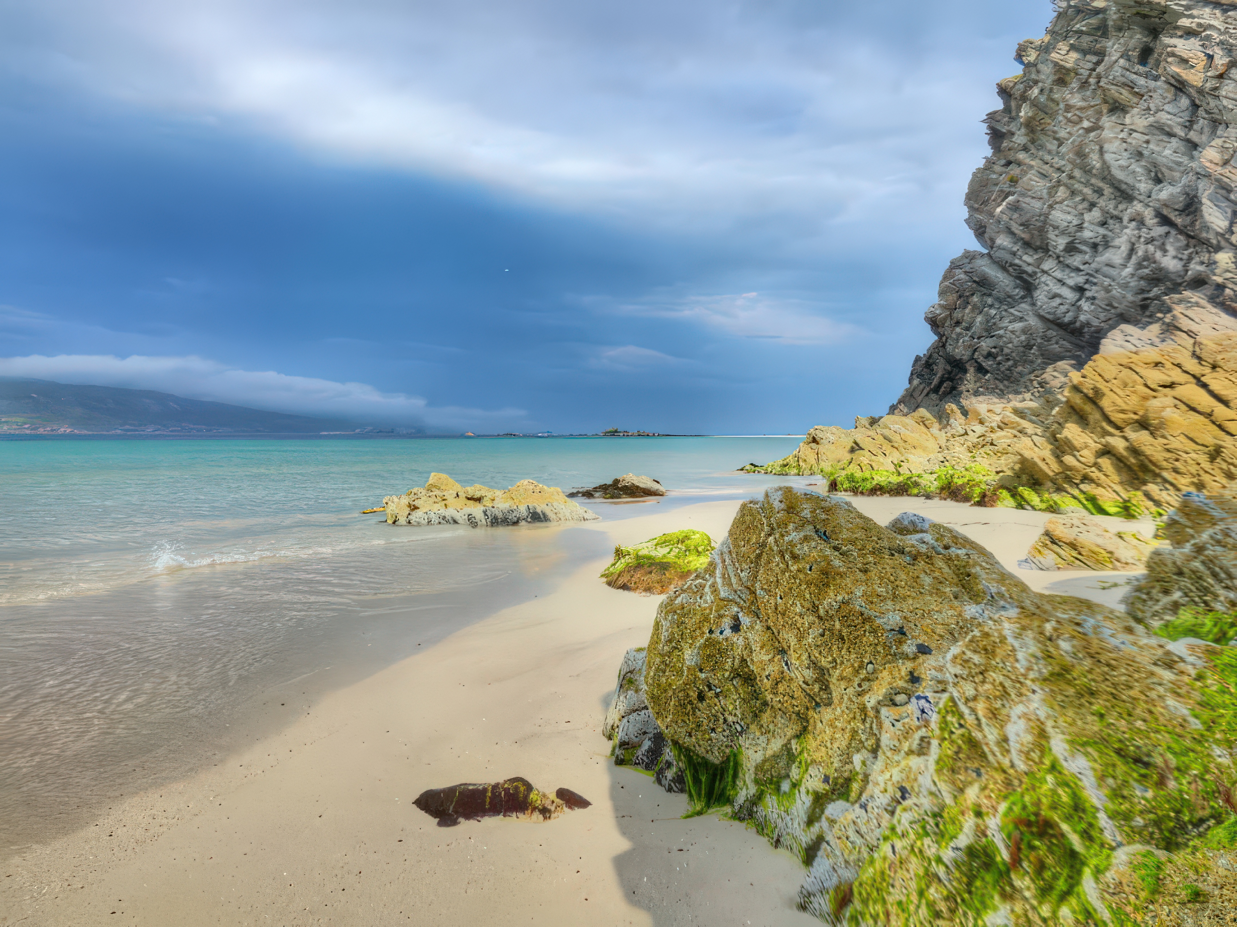 Sandy Cove Mossy Rocks Turquoise Water Cliffs